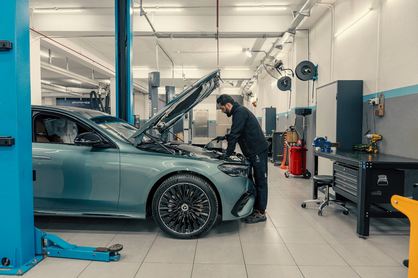 A mechanic working on a car in an auto repair shop